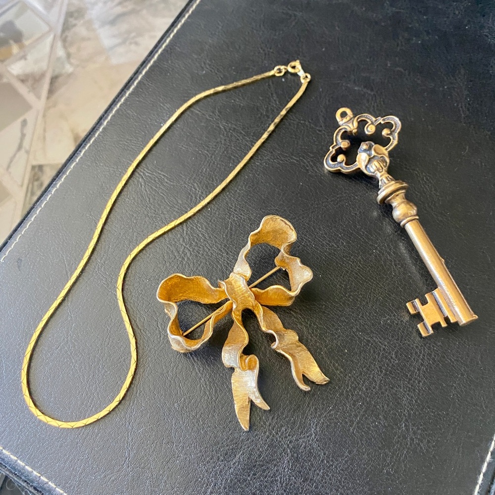 2 vintage brooches and a 16” necklace 1 CORO bow brooch 14 gold vermeil